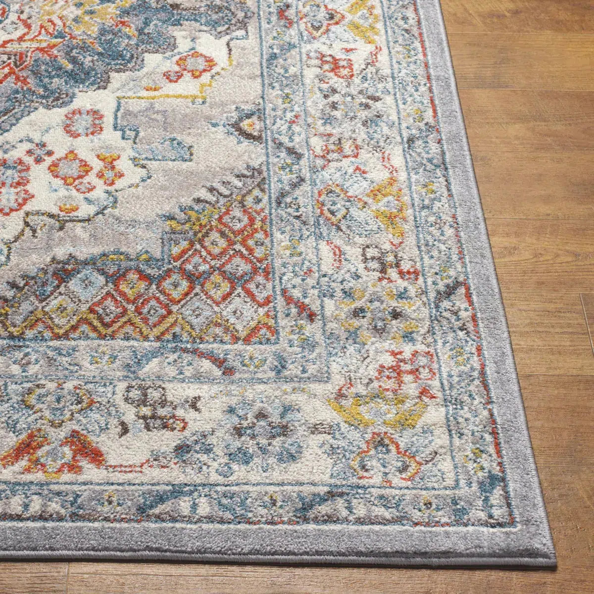Tapis SURYA Jade oriental, médaillon bleu foncé, touches rouille et moutarde sur fond gris, vue 3