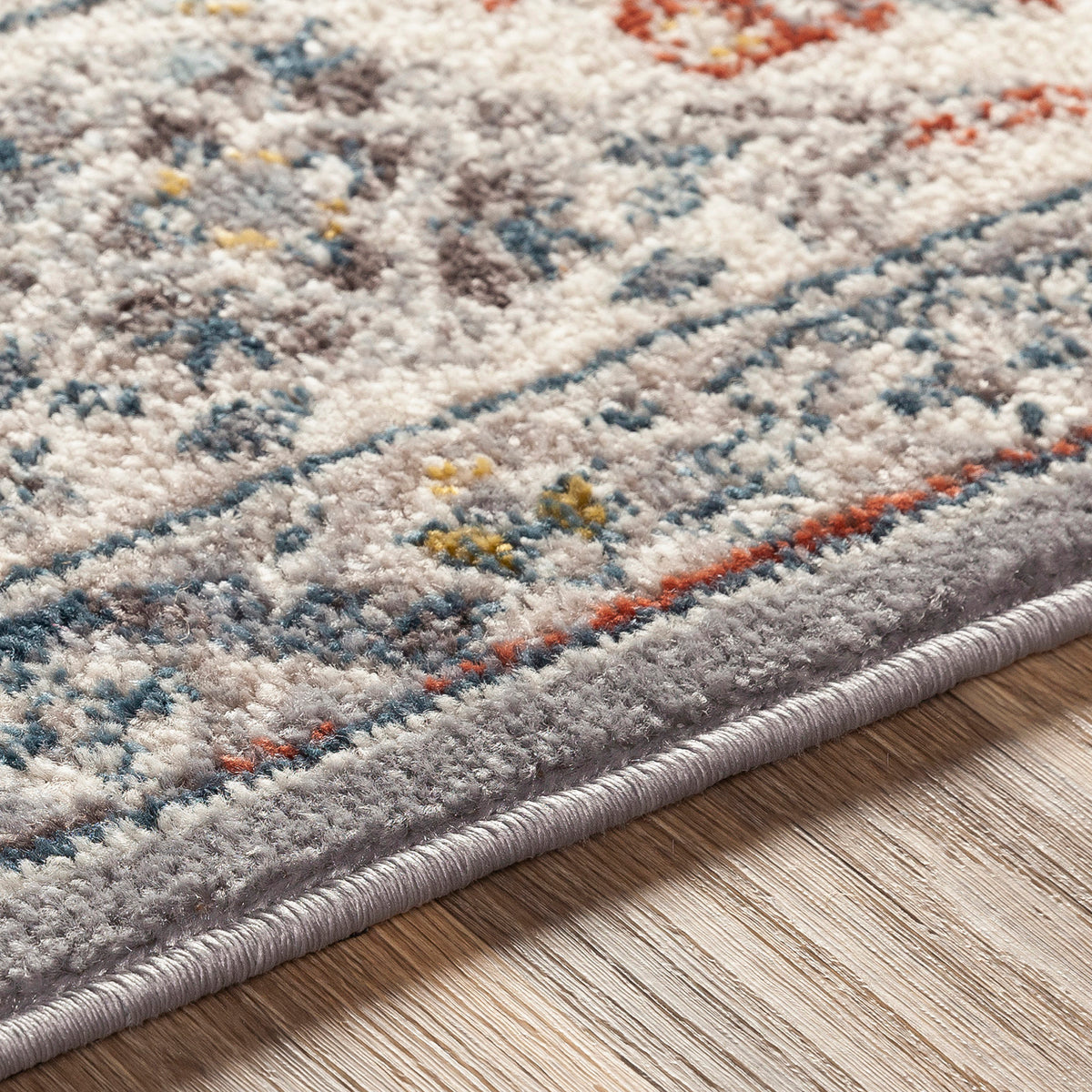 Tapis SURYA Jade oriental, médaillon bleu foncé, touches rouille et moutarde sur fond gris, vue 10